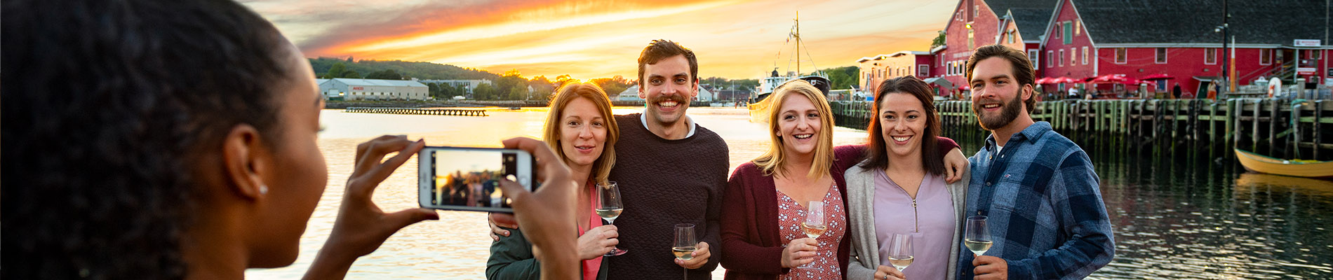 Friends take a Wharf front group Picture with Glasses of Wine